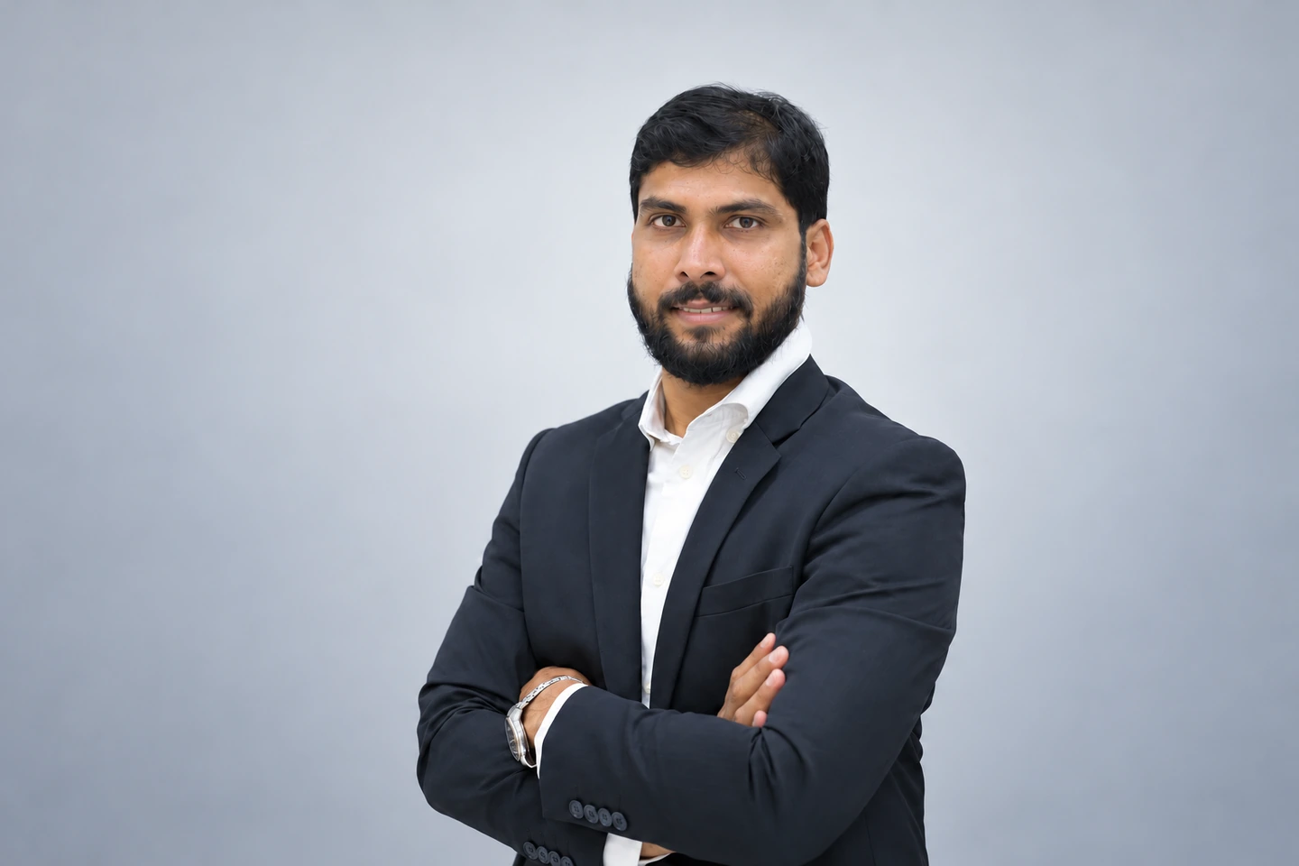 Dr. Abhijeet Kadam in a suit against a clean studio background